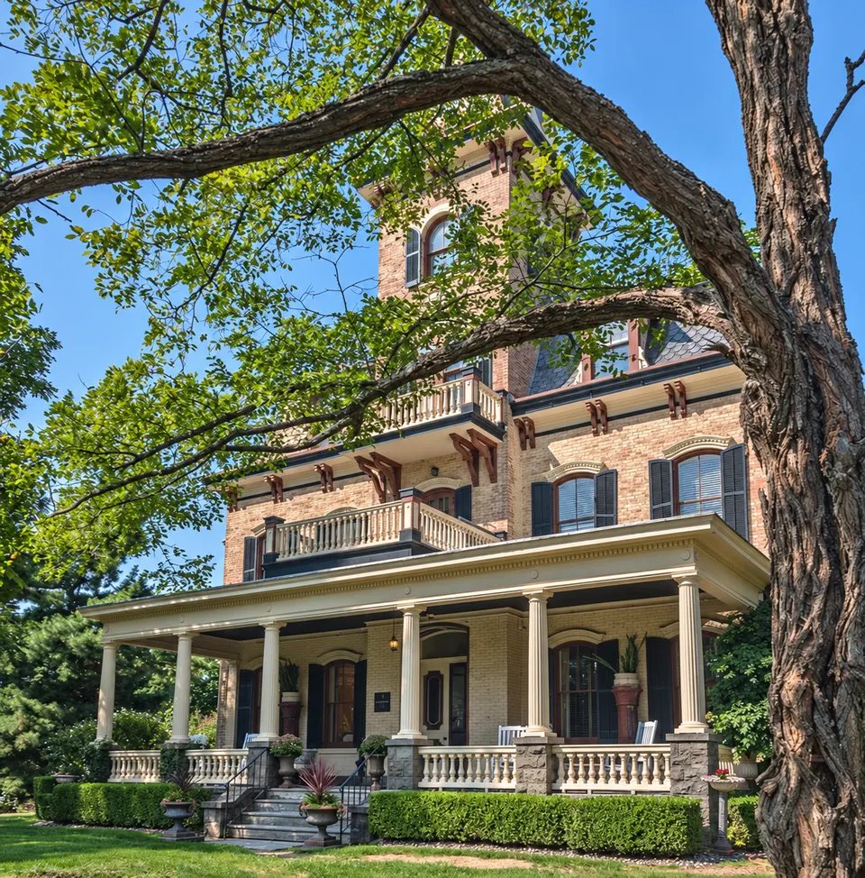 Red-brick mansion with a white columned porch
